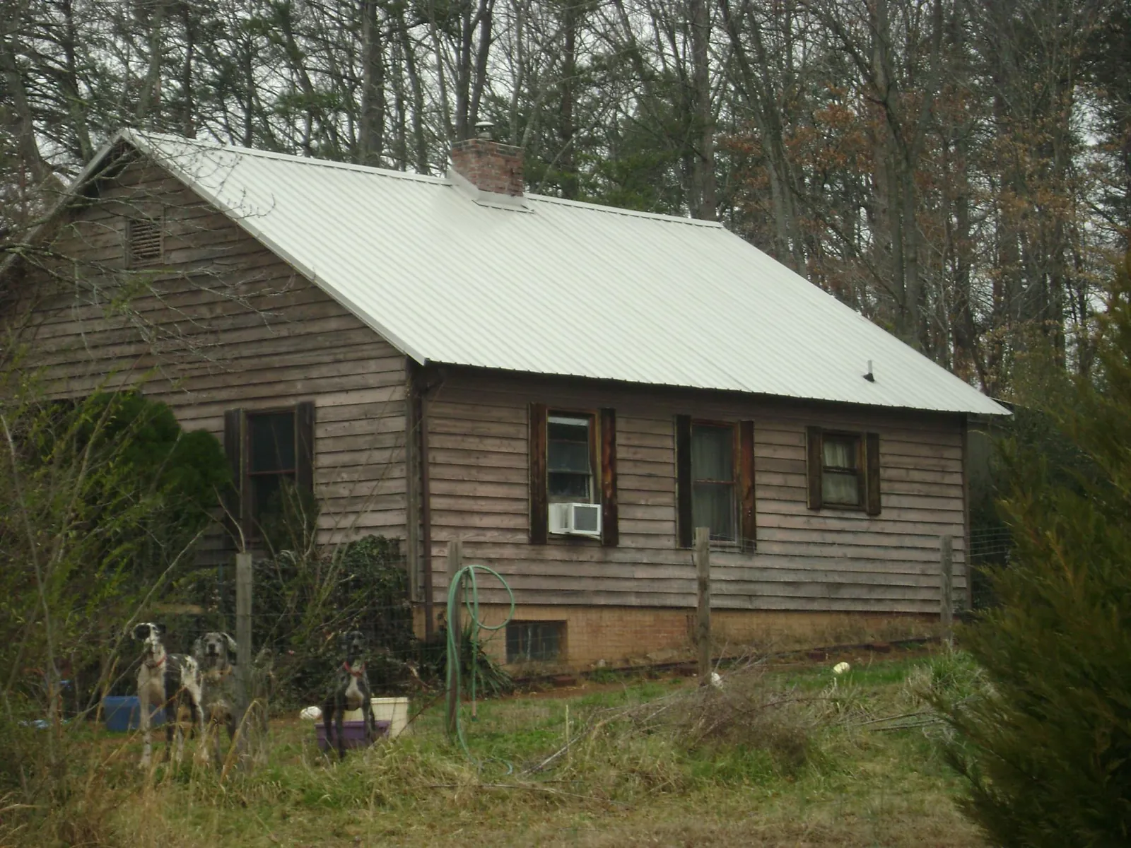White metal roof on an old wood sided farmhouse, from a Metal Roof Installation job in New Sharon